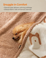 Close-up of a dog snuggled in the reversible sherpa and flannel sides of the blanket