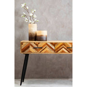 Room setting showing the mango wood console table with a lamp and decorative tray on top