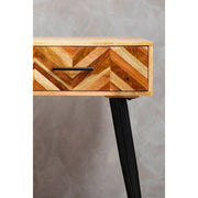 Living room setting showing the natural mango wood grain and slim black legs of the console table