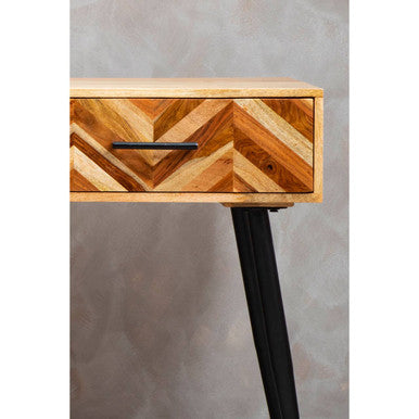 Living room setting showing the natural mango wood grain and slim black legs of the console table