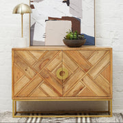 Mango wood sideboard with gold-finish legs styled in a living room