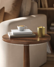 Chestnut Walnut tabletop holding a coffee cup on white books next to a gold candle