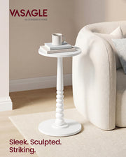 Cloud White side table beside a cream boucle sofa holding a mug and a stack of books