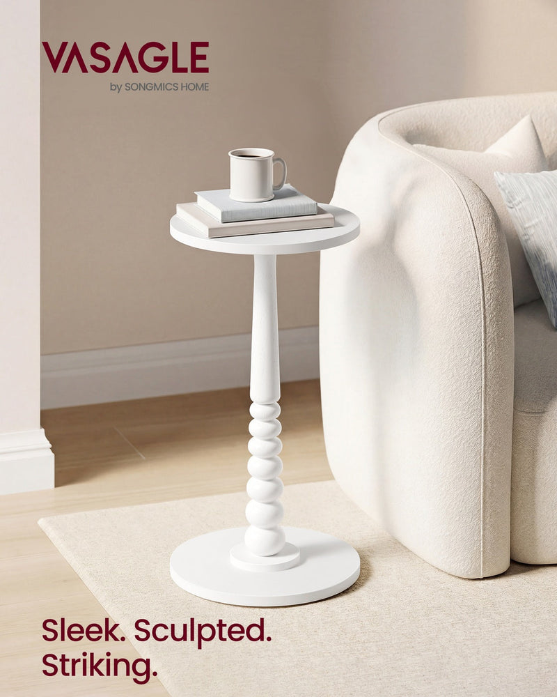 Cloud White side table beside a cream boucle sofa holding a mug and a stack of books