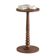 Chestnut Walnut MARIEL round side table on a plain background topped with books and a coffee cup