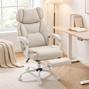 Cream white chair reclined with the footrest out beside a standing desk