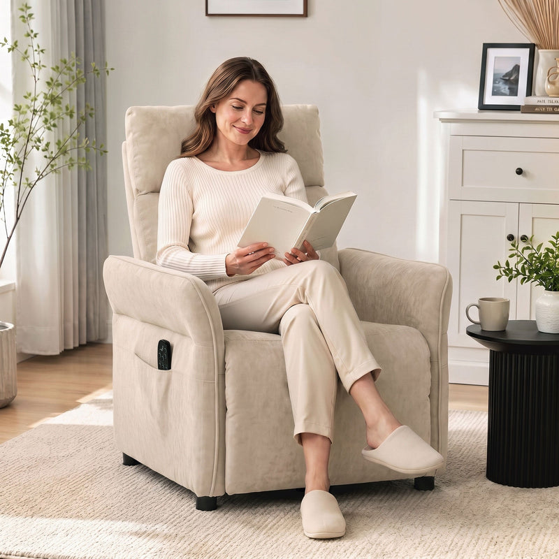 Woman sitting upright reading in the beige recliner armchair