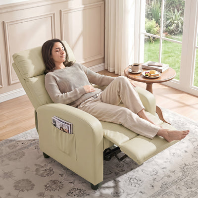 Woman reclining in the cream white recliner armchair beside a window with a coffee table