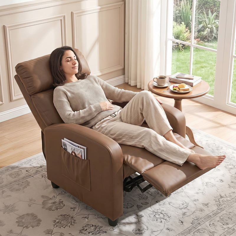 Woman reclining in the dark brown recliner armchair beside a window with a coffee table