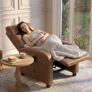 Woman relaxing reclined in the dark brown recliner armchair under a blanket