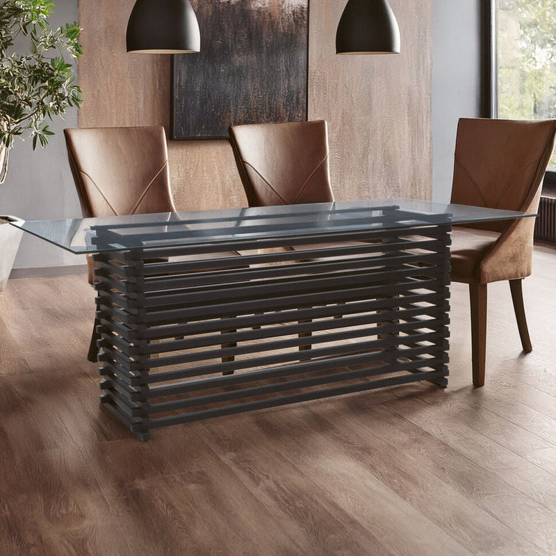 Clear glass dining table with slatted matt black base set for six in a modern dining room