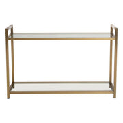 Matte gold stainless steel console table with clear glass top and lower shelf on a plain background