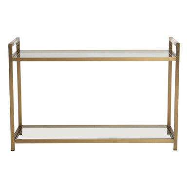 Matte gold stainless steel console table with clear glass top and lower shelf on a plain background