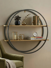 Matte gold and grey wall shelf styled with decor on a wall