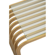 Close-up of the rounded edge where the clear glass top meets the gold frame