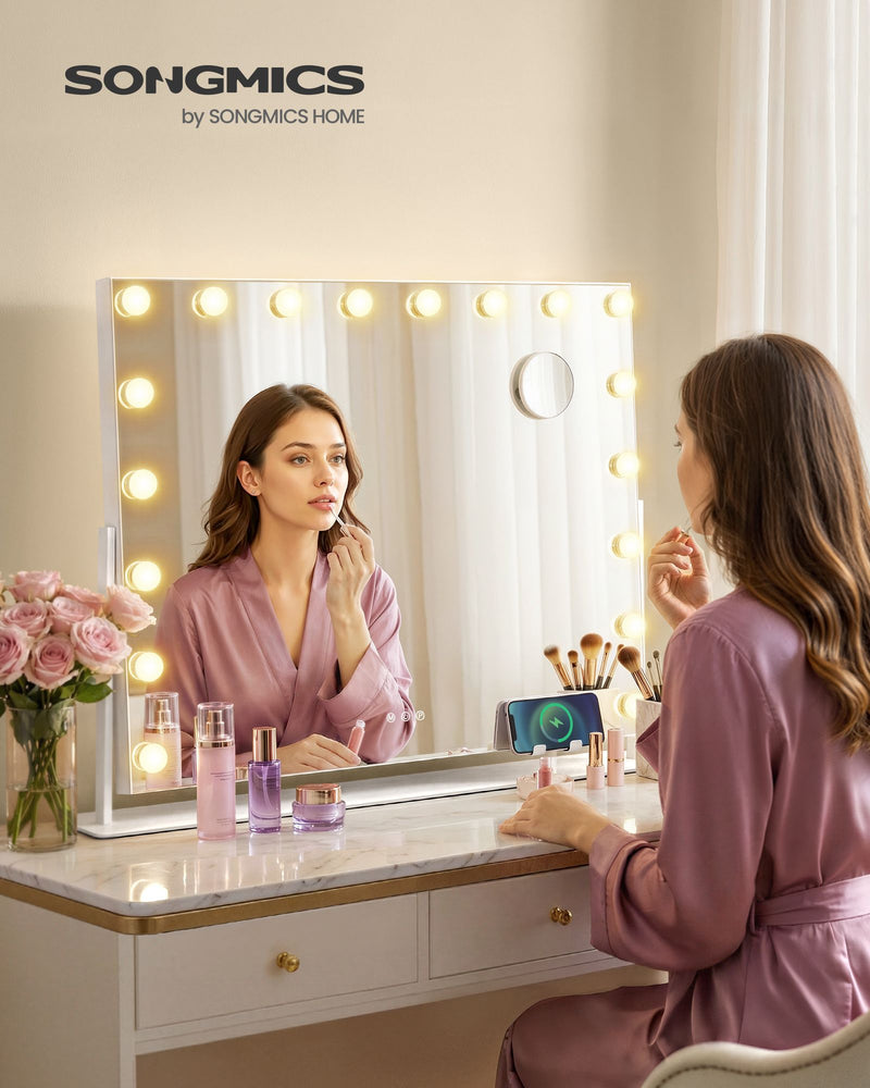 Woman doing her makeup at a dressing table with the lit vanity mirror