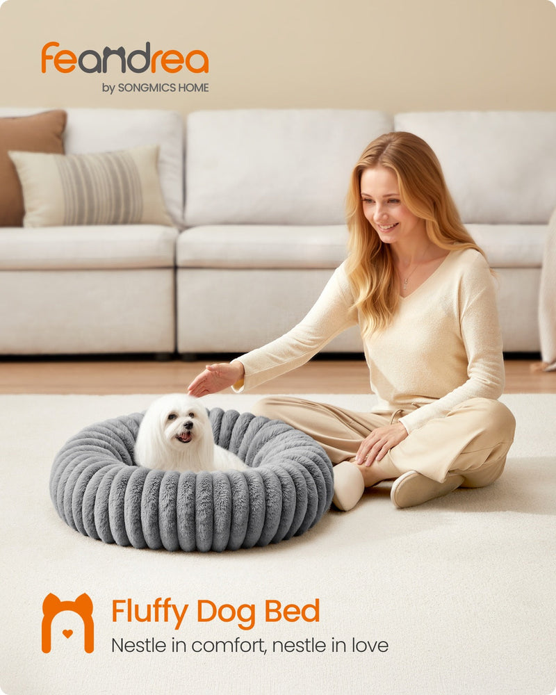 Lifestyle photo of a dog resting in the Feandrea dove grey pet bed beside its owner in a living room
