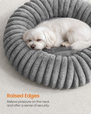 Close-up of a dog leaning against the raised rim edge of the Feandrea dove grey pet bed
