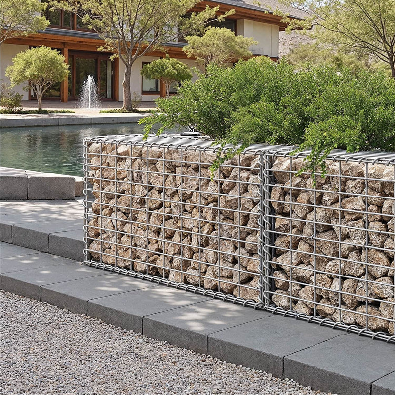 Row of stone gabion baskets forming a low wall beside a garden water feature