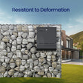 Gabion stone wall with an integrated letterbox outside a modern home