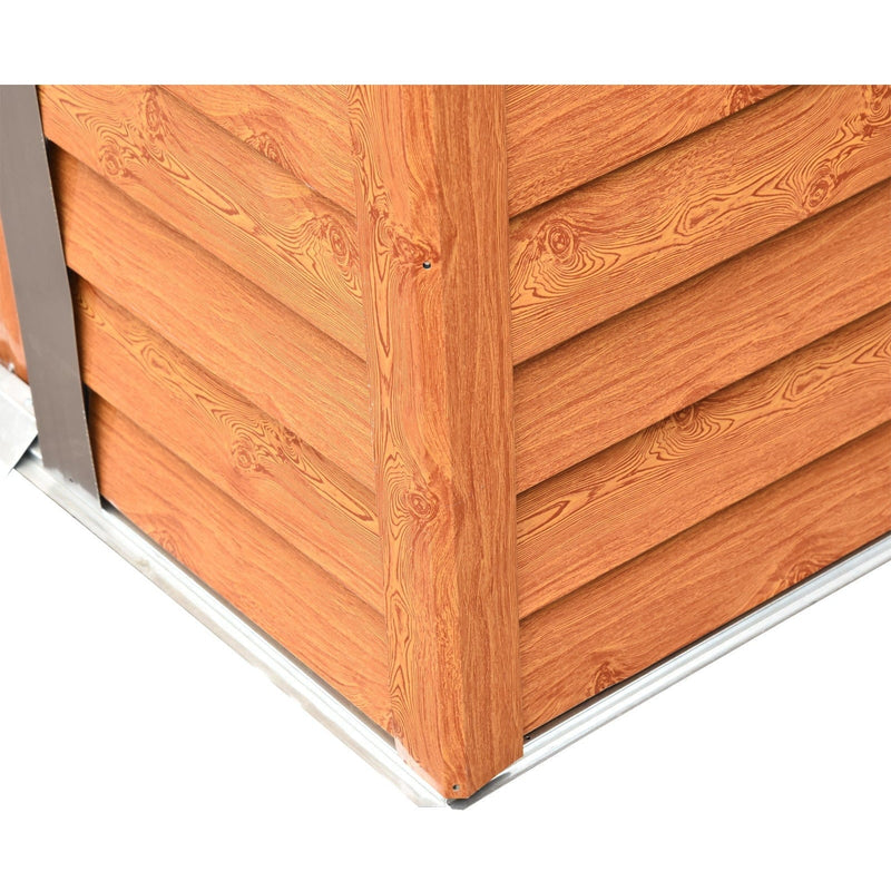 Close-up of the shed's corner post where the brown cladding panels meet the galvanised steel base frame