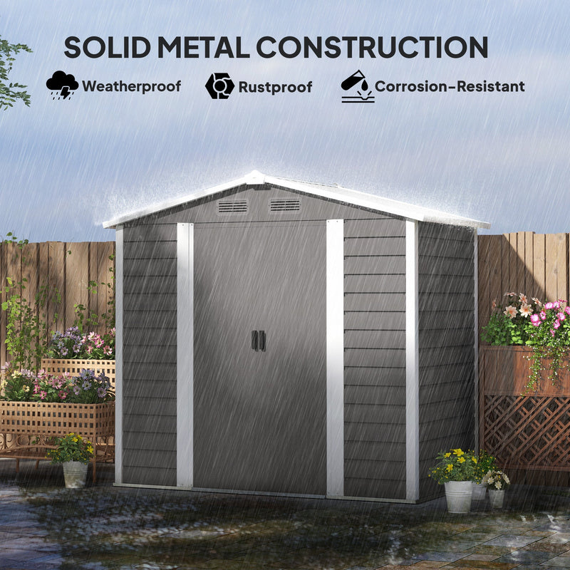 Light grey metal shed in heavy rain, showing the weatherproof, rustproof and corrosion-resistant steel panels