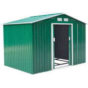 Green shed at an angle with one sliding door open, revealing the steel floor frame inside