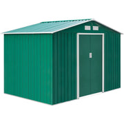 Green metal shed from the rear corner showing the ribbed side wall and closed doors