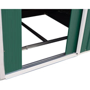 Green shed doorway with the door slid fully open, showing the track and black steel floor frame