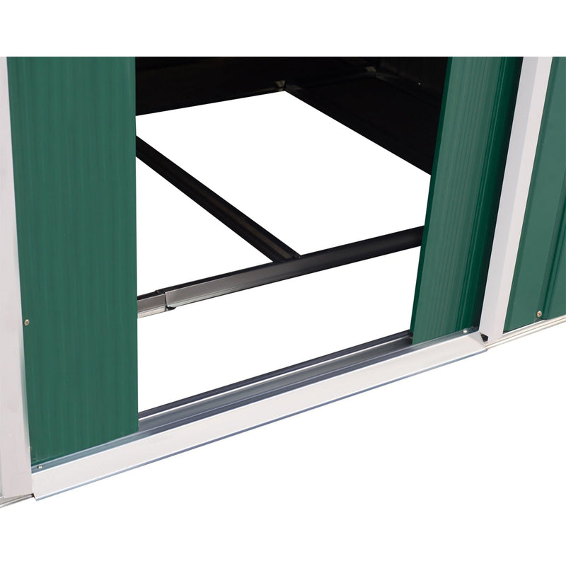 Green shed doorway with the door slid fully open, showing the track and black steel floor frame