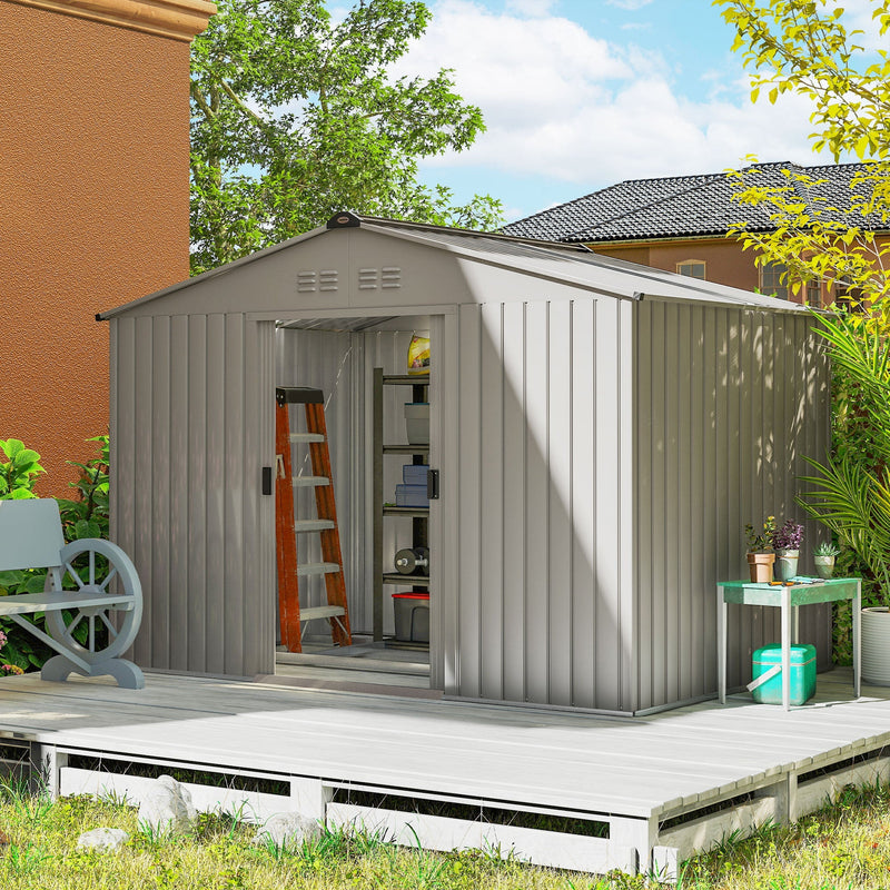 9x6ft silver grey metal shed on a decked patio with its sliding doors open