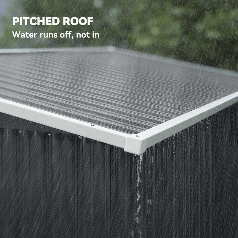 Rain running off the sloped pent roof edge of the dark grey metal shed