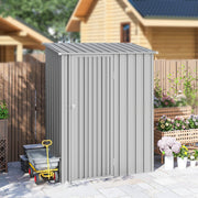 Pent roof metal shed beside a dark wooden fence with a garden trolley alongside