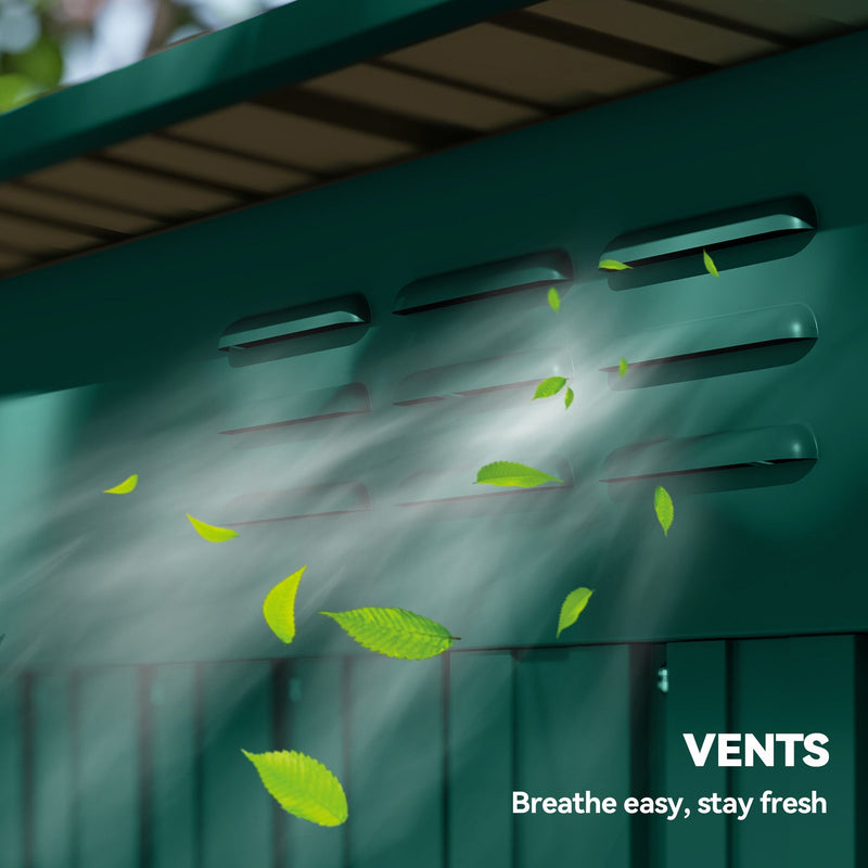 Close-up of the roof vent slots on the green shed with leaves blowing past