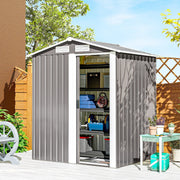 Apex metal shed on a patio with the sliding door open showing tools and boxes inside