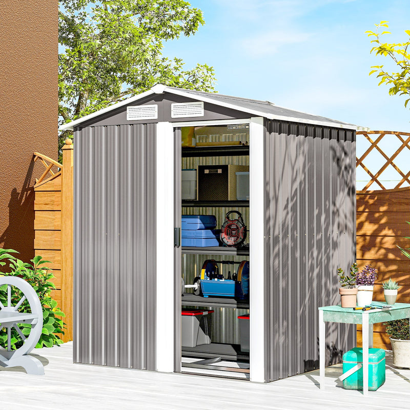 Apex metal shed on a patio with the sliding door open showing tools and boxes inside