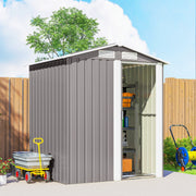 Angled view of the grey shed with the door open, a hose reel and a garden trolley alongside