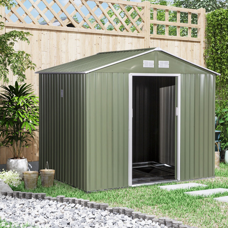 Light green shed in a garden beside a trellis fence with the door open