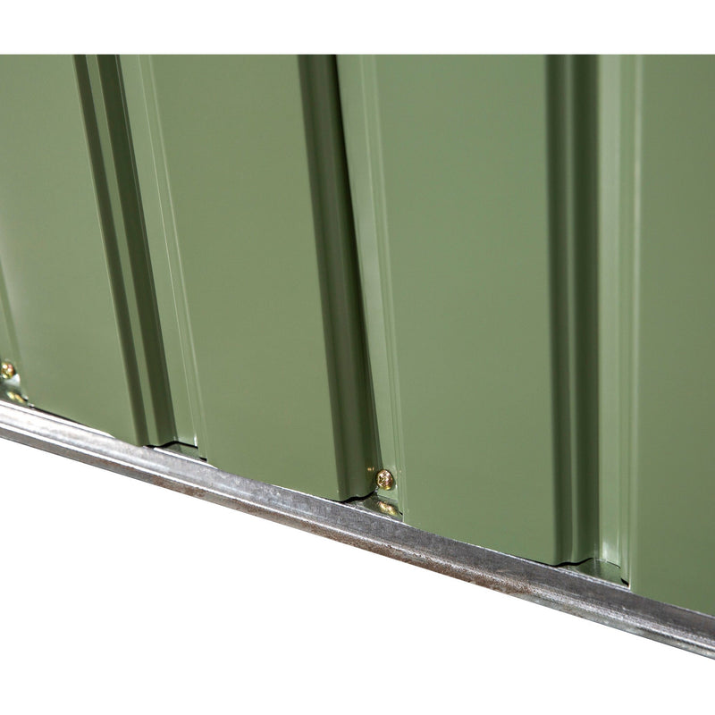 Close-up of a light green wall panel meeting the galvanised base rail
