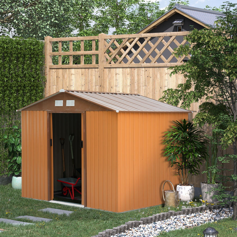 Tan yellow shed in a garden with a trellis fence and pots, door open