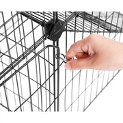 Close-up of a hand opening the playpen side door by its metal latch ring