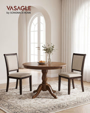 Light beige Vasagle dining chairs around a round wood dining table