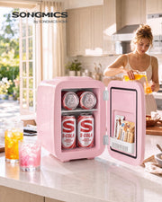 Pink mini fridge on a kitchen worktop filled with cans of cola while a woman pours a drink behind
