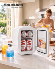 White Songmics mini fridge on a kitchen worktop stocked with cans of cola and snacks in the door