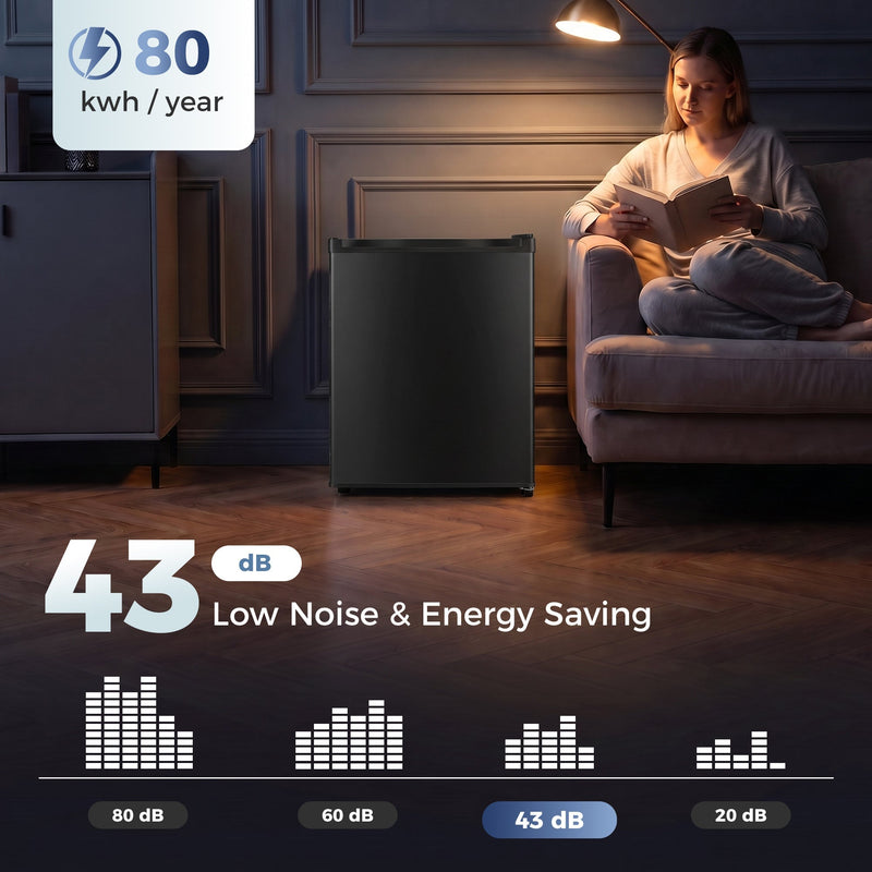 Black mini fridge in a dim living room with 43 dB and 80 kWh a year labels