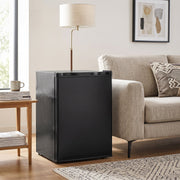 Black mini fridge next to a sofa and side table in a living room
