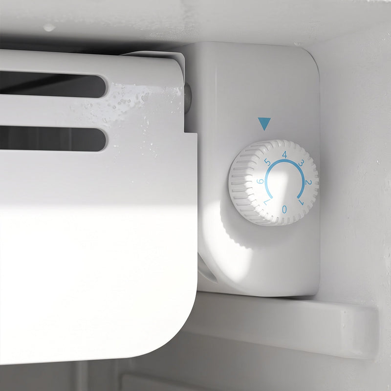 Close-up of the thermostat dial inside the fridge compartment