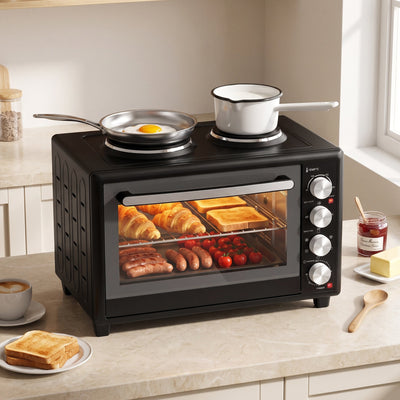 46L mini oven on a kitchen worktop with a frying pan and saucepan on the hotplates and breakfast cooking inside