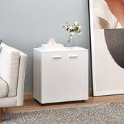 White sideboard in a living room with flowers and ornaments on top