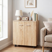 Natural wood sideboard beside a sofa with a lamp and books on top